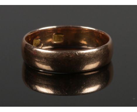 A rose gold wedding band. Size R 1/2. 4.47g.  Marks indistinguishable.