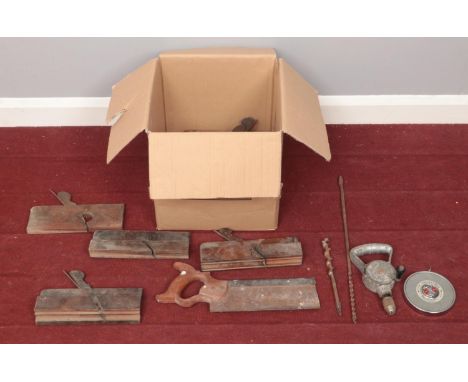 A box containing vintage tools. To include a hand saw, eight wood plains, a chesterman tape measure and a Laytool hand held d