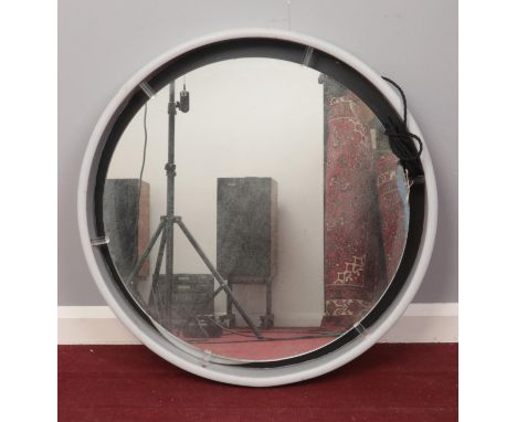 A large framed circular electrical mirror. H: 77cm.  Condition fair. The light doesn't seem to be working and will need atten