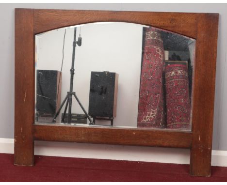 A large Oak framed bevelled edged mirror. H: 92cm, W:114cm.  Condition good. Just scuffs and scratches to the frame.