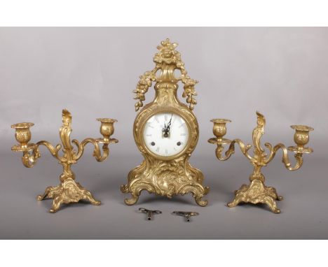Italian cartouche shaped gilt metal clock garniture. The white enamel dial signed 'Imperial' with roman numerals houses a twi