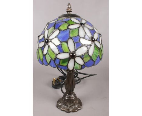 A Tiffany style table lamp with lead glazed shade. Decorated with flowers. (35cm tall)  