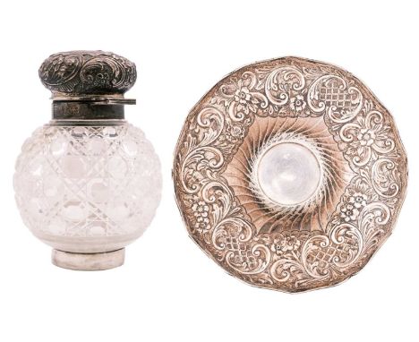 An Edwardian silver and cut glass inkstand by Army & Navy Cooperative Society Ltd. The large ovoid bottle with a foliate scro