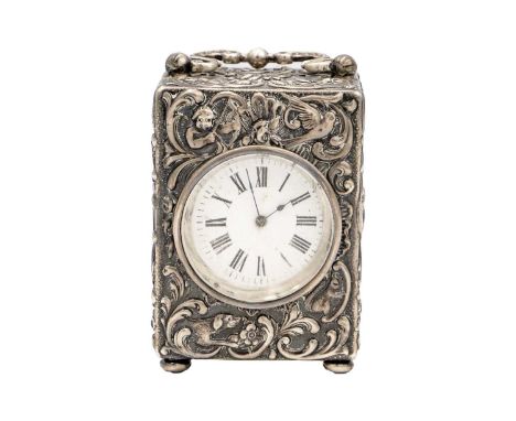 A Victorian silver boudoir carriage clock by Mappin Brothers. Profuse foliate scroll, cherub, bird and hound embossed decorat