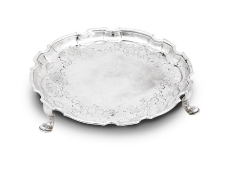 A George II waiter or teapot stand By James Glen, Glasgow, Circa 1743-56 on three scroll feet with shaped rim and chased bord
