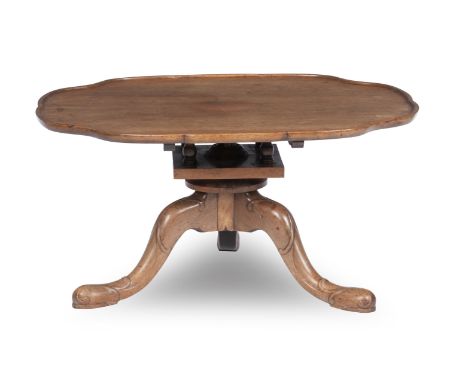 A Walnut Coffee TableAttributed to Whytock and Reidwith oval shaped and moulded top, attached to a tripod support by a birdca