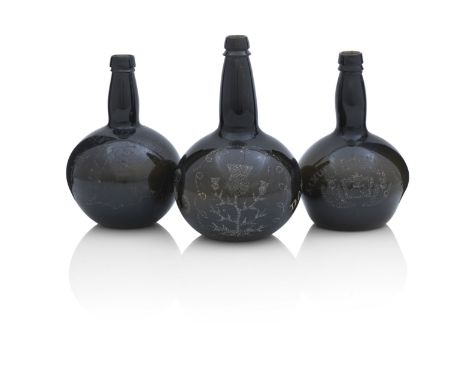 Three dated early Victorian chip-engraved bottlesThe first of shaft and globe form and of dark green tint, chip engraved with
