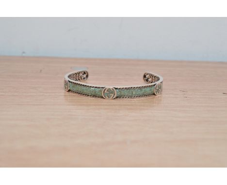 A Gucci white metal and resin bangle, with import marks for AG 925, and the Gucci logo