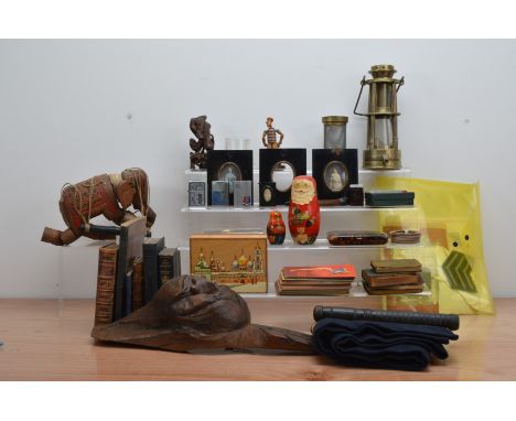 A large collection of assorted works of art, including a brass minors lamp, a toy elephant puppet, a tortoise shell cigarette