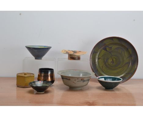 A collection of studio pottery, comprising a footed dish with a textured top with orange and brown glaze with brush decoratio