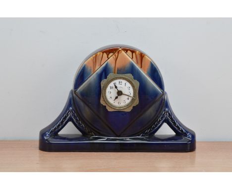 An art deco style ceramic glazed mantle clock, enamel dial with Arabic numerals, multi-coloured glazed, predominantly blue, 2