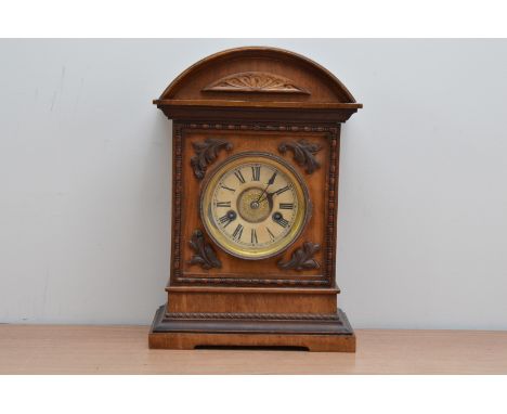 An early to mid 20th century German wooden cased mantle clock, of classic form, stained dial, pendulum and winder present 37c