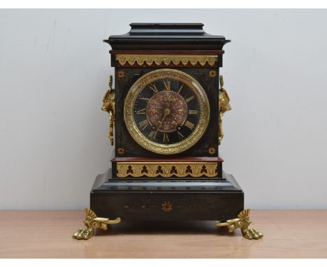 A Victorian slate and gilt mantle clock,  the dial with engraved in gilt roman numerals and a copper centre, lion head handle