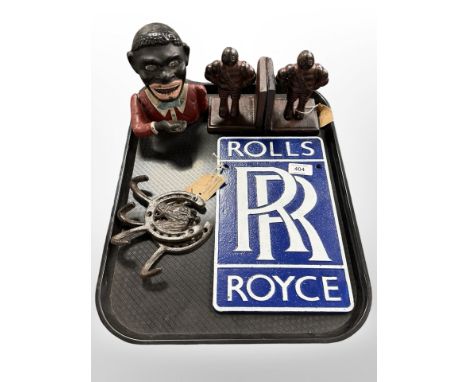 A cast iron money box, pair of Michelin Man bookends, Rolls Royce plaque and a pair of coat hooks Notice from the the-saleroo