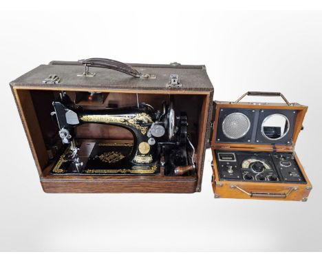 A Singer hand sewing machine and a Spirit of St Louis radio alarm clock.
