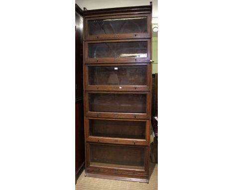 A mid century Lebus oak finished six section glass fronted bookcase with pediment and plinth, 231cm x 89cm&nbsp;