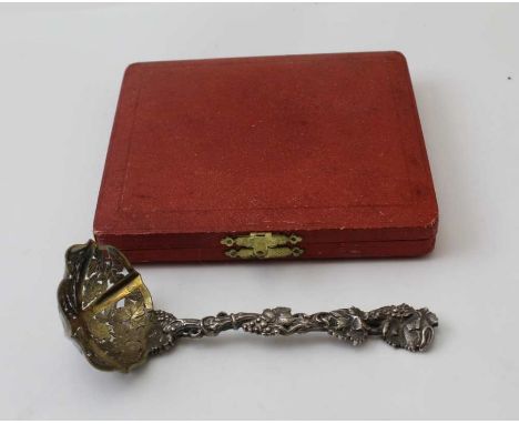 Francis Higgins ll, a Victorian silver sifting ladle, fruiting vine cast handle, gilded bowl, London 1858, 80g,&nbsp; togethe