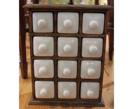 A spice rack with porcelain drawers.