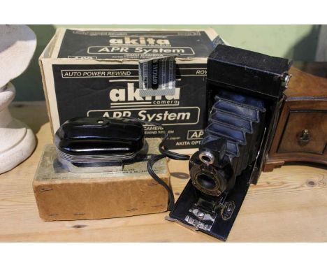 A boxed unused Akita APR 35mm camera, 2A folding Brownie camera and a boxed Lucas portable iron of art deco design