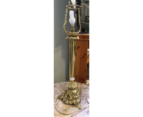 A brass table lamp, with decorative base