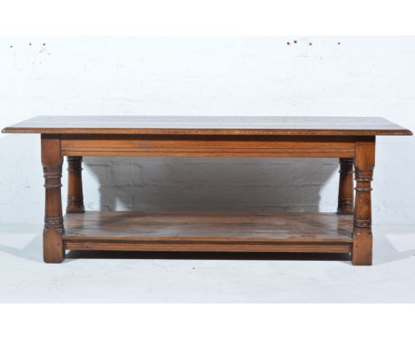 Modern oak coffee table, rectangular top with a moulded edge, turned legs joined by a boarded shelf, the top 133cm x 161cm, h