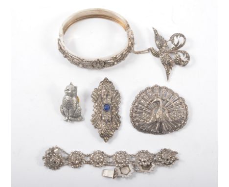 A collection of silver and white metal marcasite jewellery, half hinged bangle, bracelet, brooches. (6)