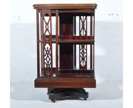 Victorian inlaid mahogany revolving bookcase, serpentine outline, inlaid arrow and swag roundel, box strung outline, with two