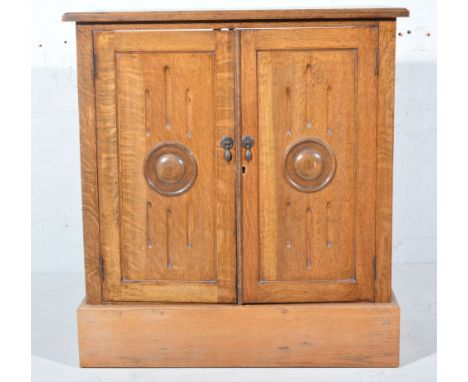 Oak side cabinet, rectangular top with a moulded edge, two carved panelled doors enclosing a shelf, plinth base, width 77cm, 