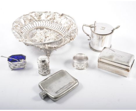 Silver drum mustard beaded outlines; silver salt and pepper with blue glass liners; napkin ring; flask; and a plated basket.