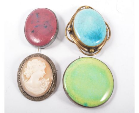 Three Arts and Crafts ceramic brooches and a cameo brooch, a turquoise Ruskin brooch 40mm x 30mm, in a gold-plated mount, a p