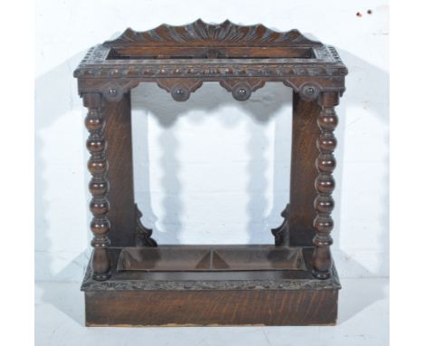 Victorian carved oak stick stand, bobbin turned supports, plinth base, width 62cm, depth 27cm, height 74cm.