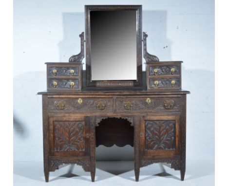 Victorian carved oak dressing table rectangular bevelled plate above trinket drawers, the base with a rectangular top and mou