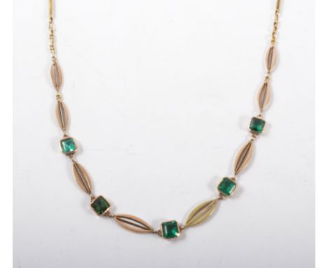 A gemset necklace, five green step cut stones individually collet set and spaced by marquise shaped links all set in yellow m