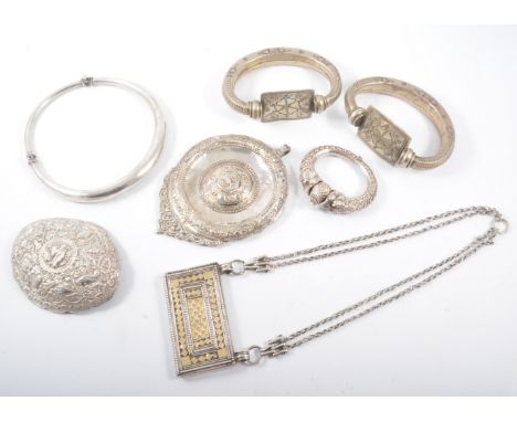 A collection of middle eastern jewellery, two white metal ankle bangles, a graduated torque design collar, a double serpent b
