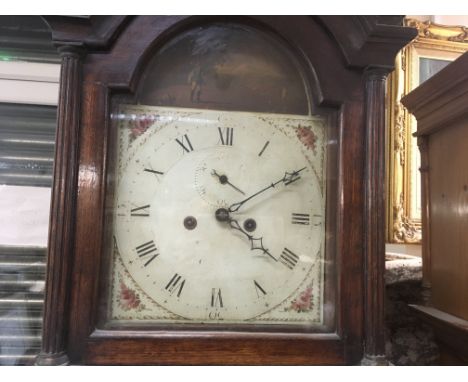 A oak 8 day long case clock the painted dial with Roman numerals.