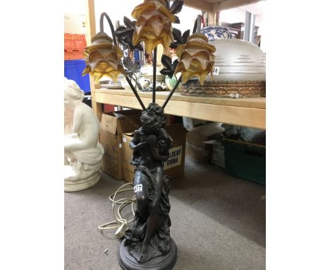 A figural lamp depicting a semi clad maiden, approx height 87cm.