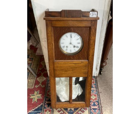 A 1940s oak wall clock with Jay Ferers movement.