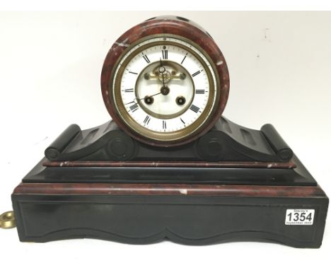 A Victorian black slate and marble mantel clock with a visible escapement. 45cm wide