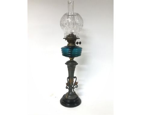 Victorian oil lamp with unusual base, blue glass reservoire and heavy cut glass shade