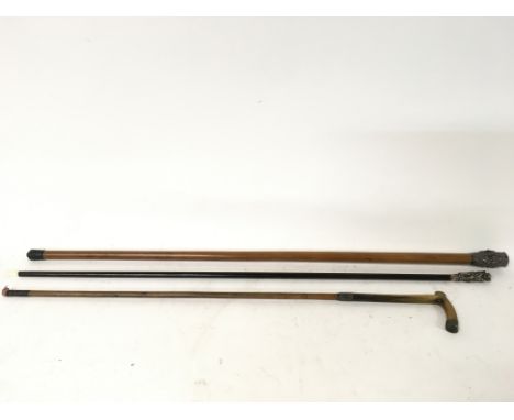 Walking sticks- Ebonized stick topped with monk and woman, walking cane depicting Indian entities and a small walking cane wi