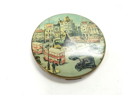 A vogue compact mirror. Approximately 4inch circumference.