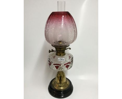 An impressive Victorian brass and cranberry glass oil lamp. 60cm.