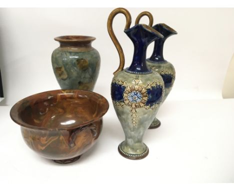 A pair of Royal Doulton stoneware Ewers a vase and a slip ware decorated bowl and three Goebel figures.