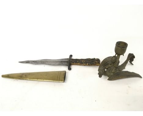 Kris blade dagger, featuring a brass scabbard and antler scale handle + A brass candlestick presenting a devil riding a drago