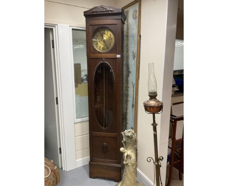A 1930s oak cased grandfather clock.