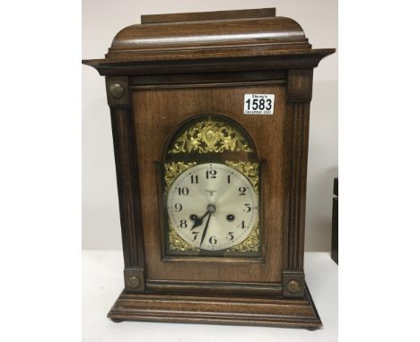 A Continental cased mantel clock with a silvered dial Hight 45cm.