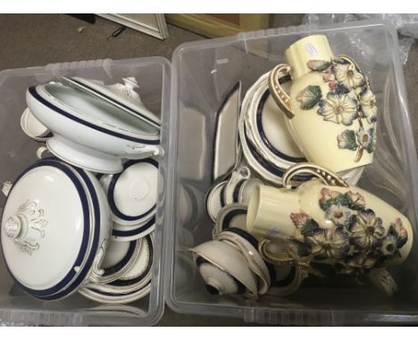 Two boxes containing a dinner service and a pair of early 20th century art vases.