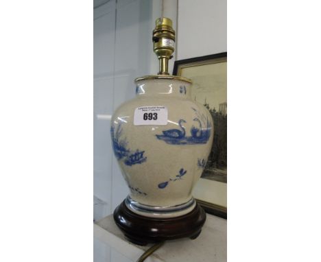 A Cracked Glaze Table Lamp with Blue Images.