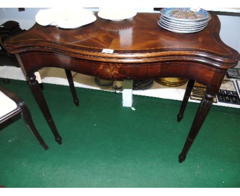 A Period Regency Serpentine Fronted Mahogany Card Table, the folding top having inset green baize, the table being or reeded 