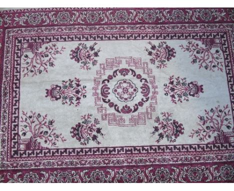 A Small Silk Carpet, with geometric motifs and multi border against a red ground